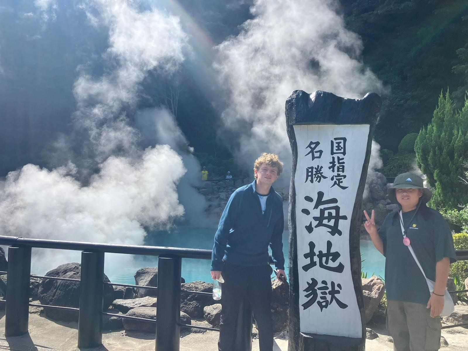 Two young men outside a hot springs.